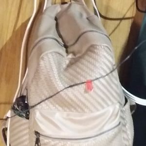 Backpack/pocketbook/bookbag and it's tan with three zipper poc.two side poc.